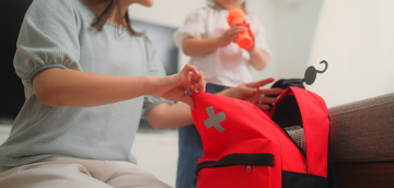 Mother opening up Emergency red bag